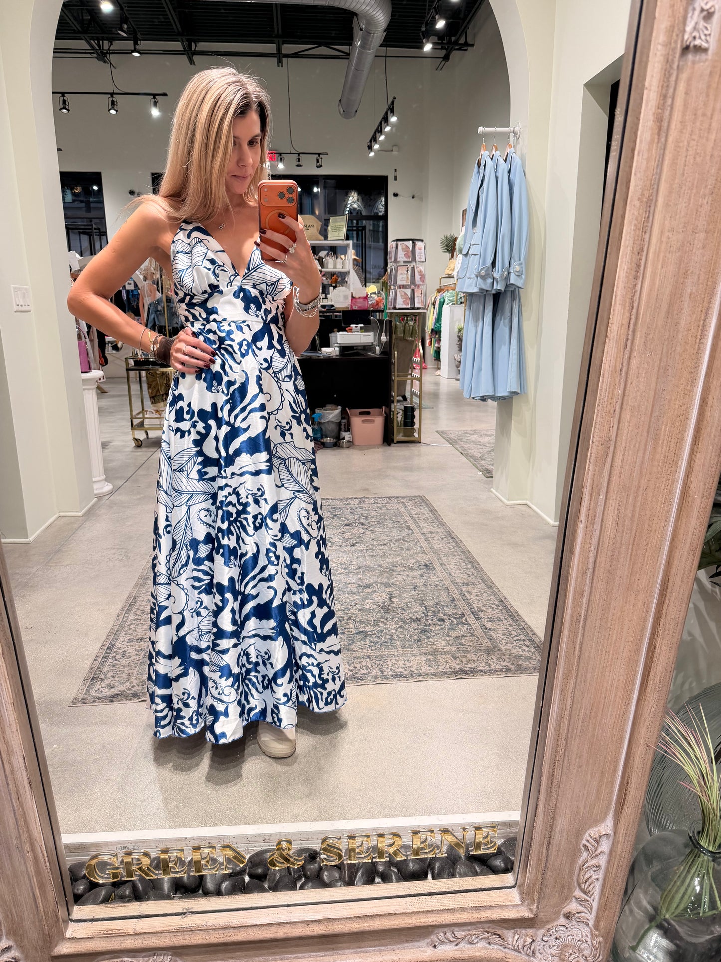 A chic blue-and-white maxi dress featuring a flattering V-neckline, cinched waist, and a flowing skirt.