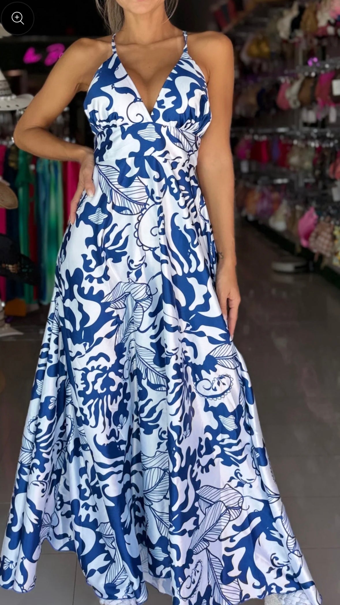 A chic blue-and-white maxi dress featuring a flattering V-neckline, cinched waist, and a flowing skirt.